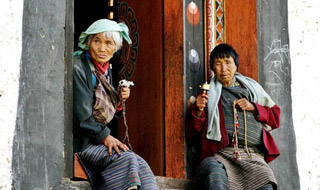Picture of Bhutanese Ladies sitting in front of a Bhutanese traditional door
